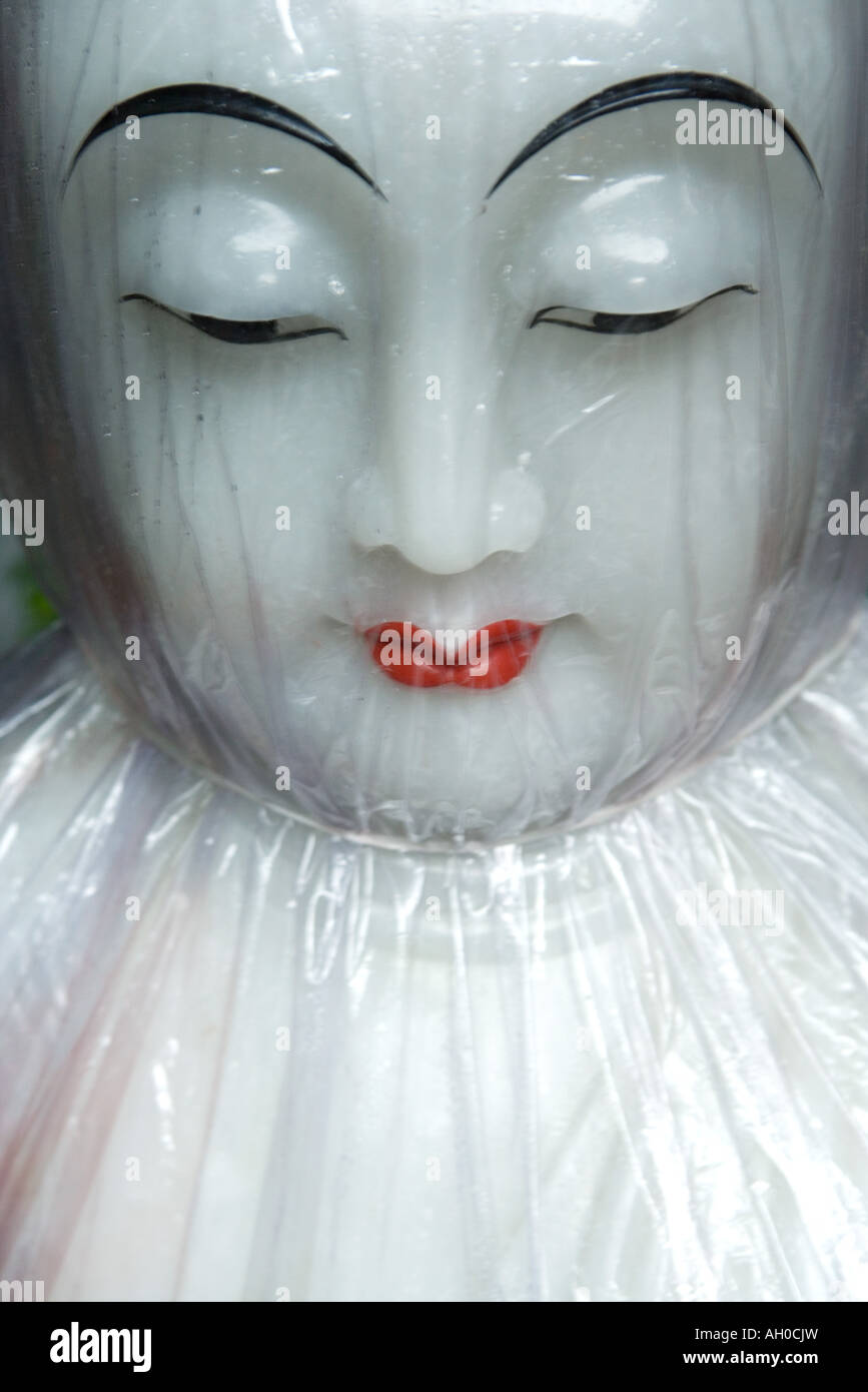 Doll face under cellophane Stock Photo
