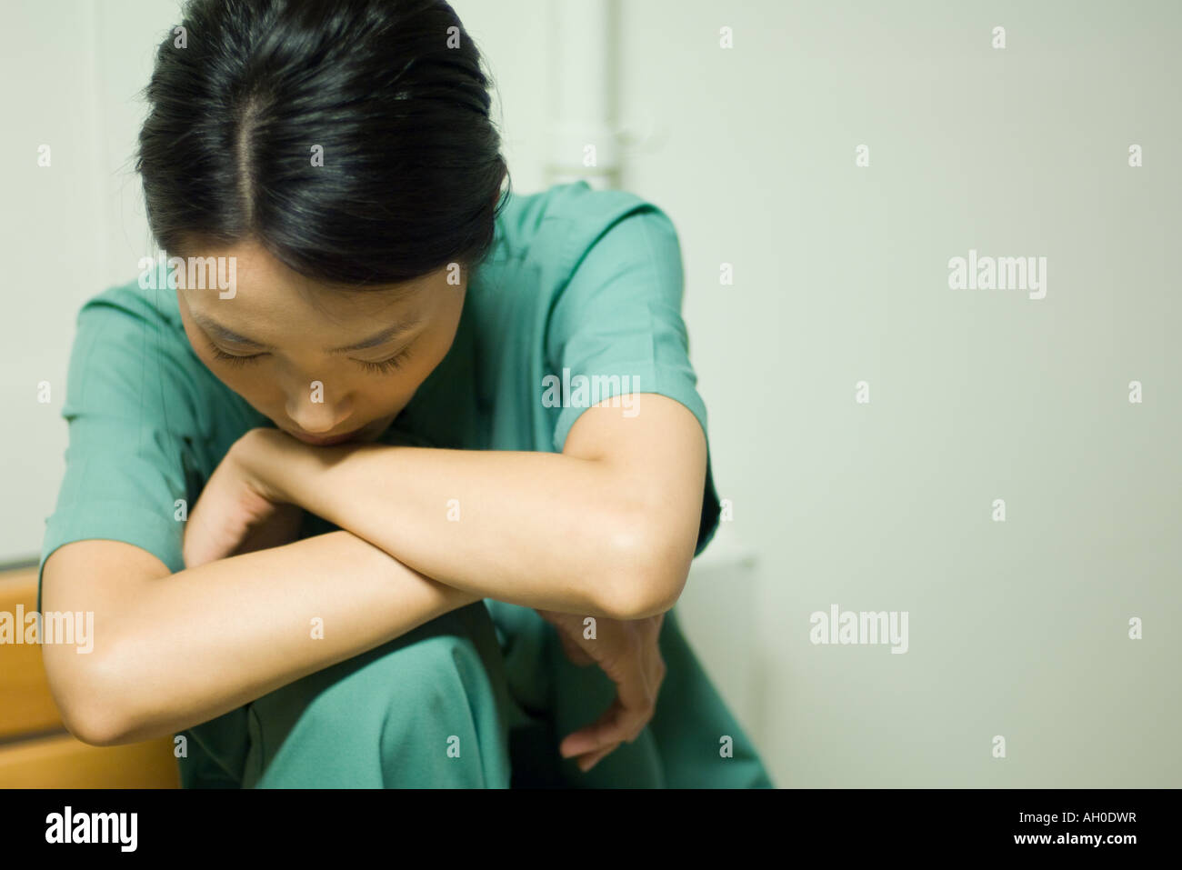 Woman resting head on arms, head down, closeup Stock Photo Alamy