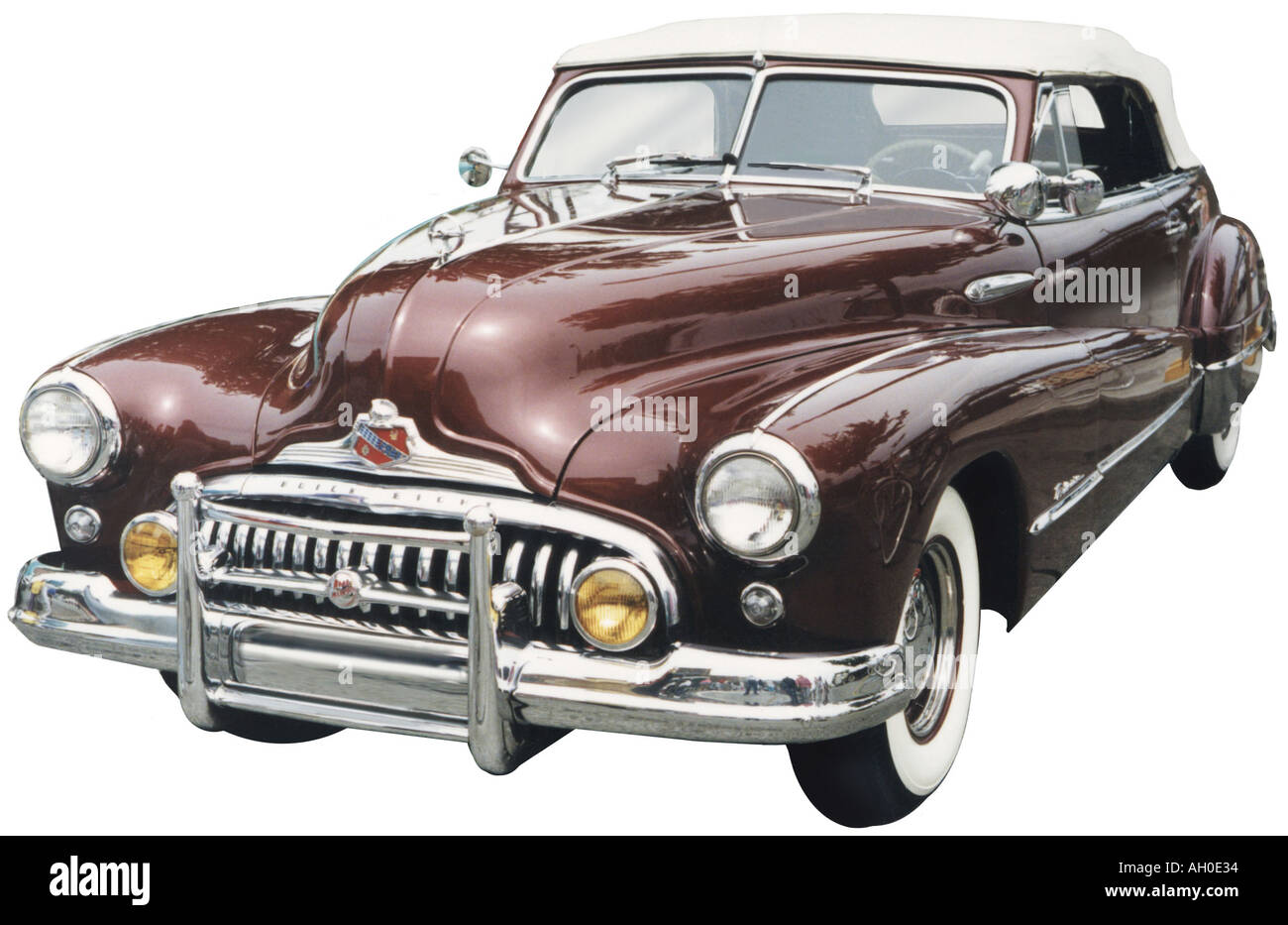 Cutout image of the front end of a maroon colored 1948 Buick Super convertible with chrome grill and yellow fog lights Stock Photo