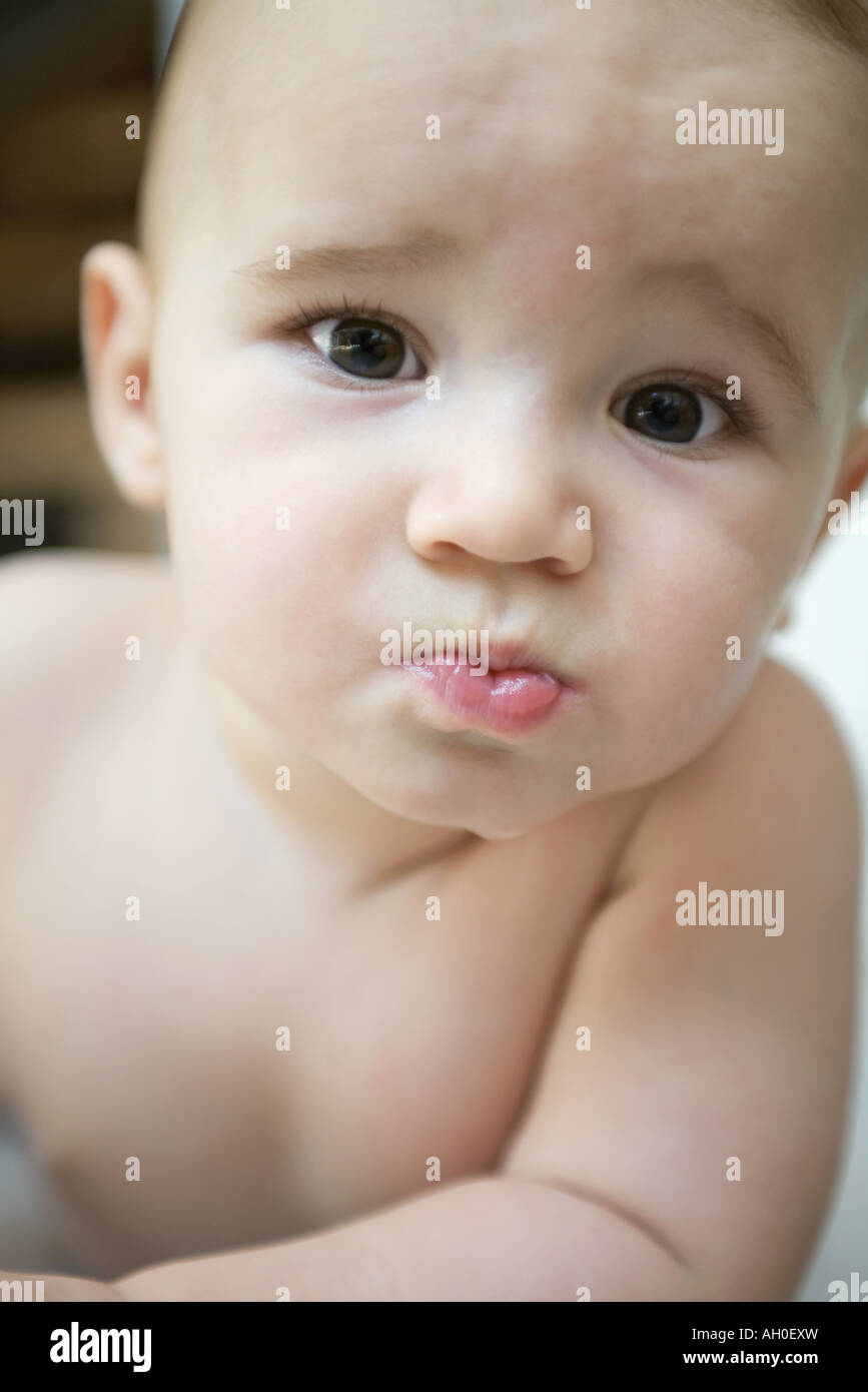 Baby frowning at camera, portrait Stock Photo