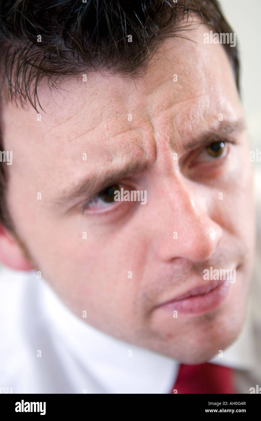 Male white collar worker looking concerned Stock Photo