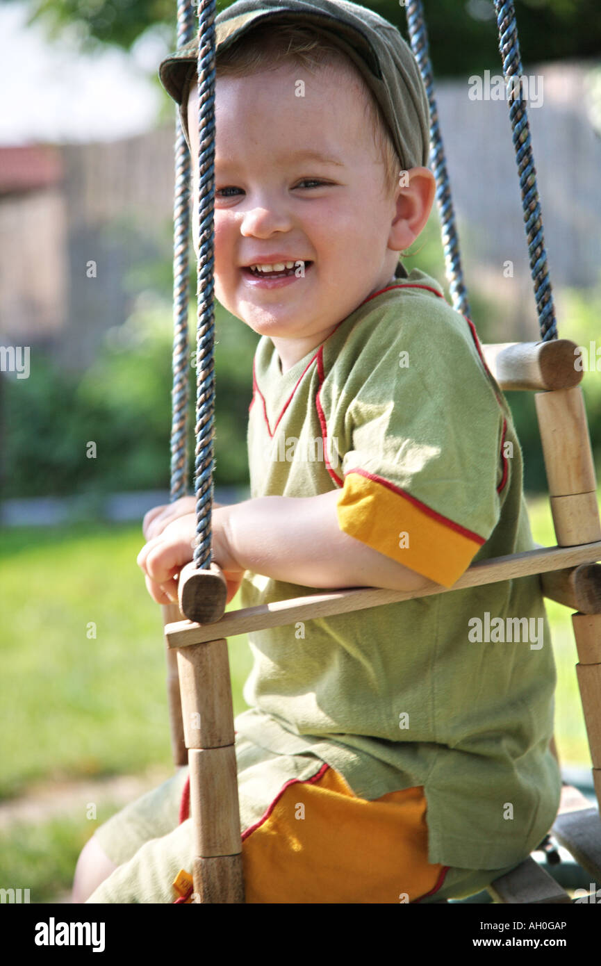 A little boy sitting on swing. Stock Photo