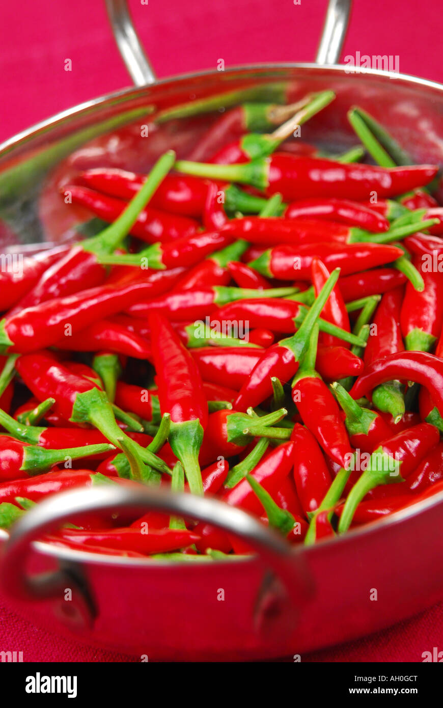 Red bird's eye chillies in a bowl. Stock Photo