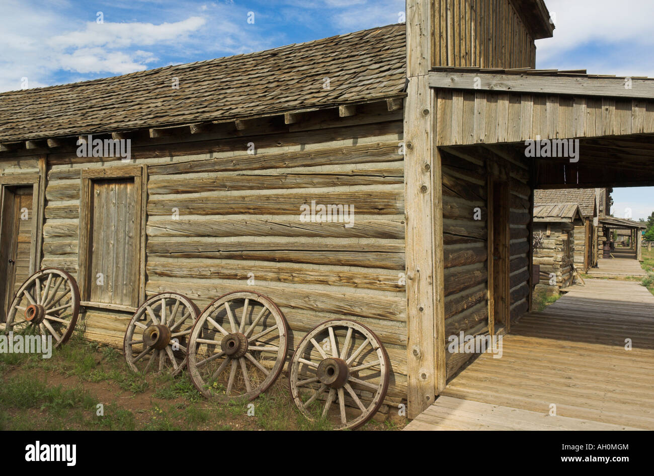 wagon wheels outside restored cabin at wild west town of cody wyoming
