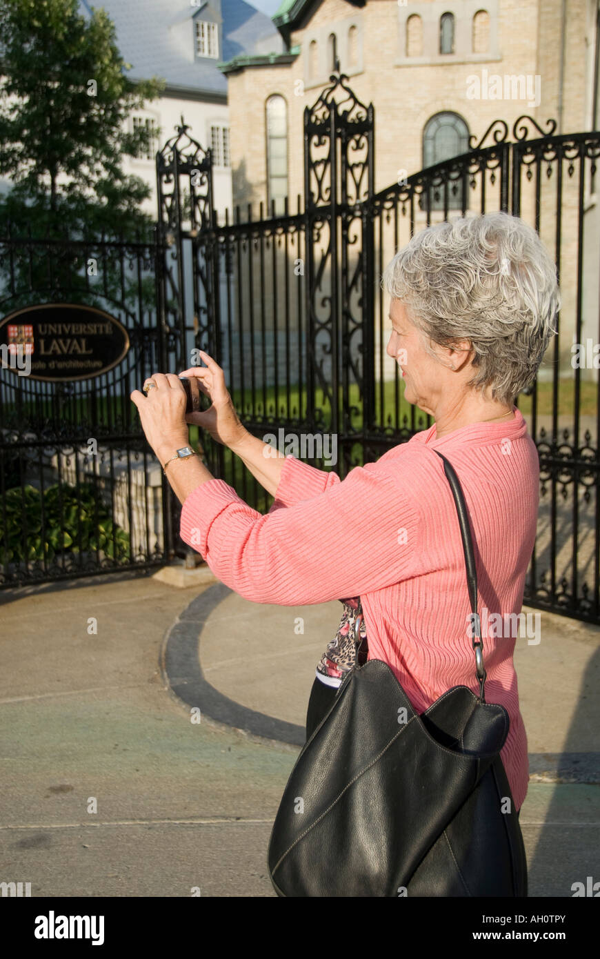 Canada Quebec Old Quebec City Mature woman taking picture of a historic building Stock Photo