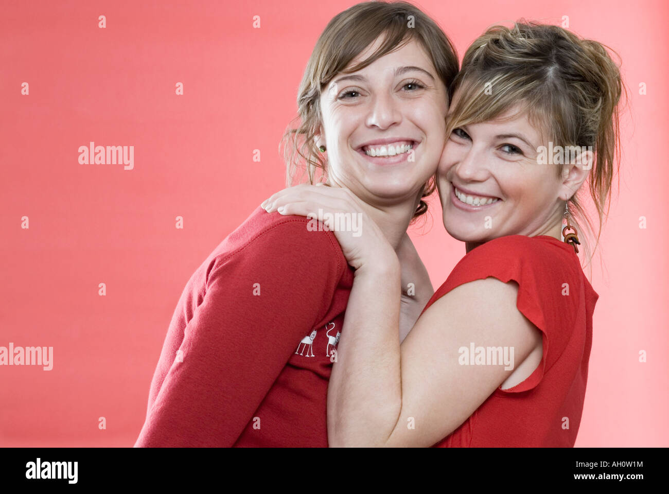Portrait of two young women smiling Stock Photo - Alamy
