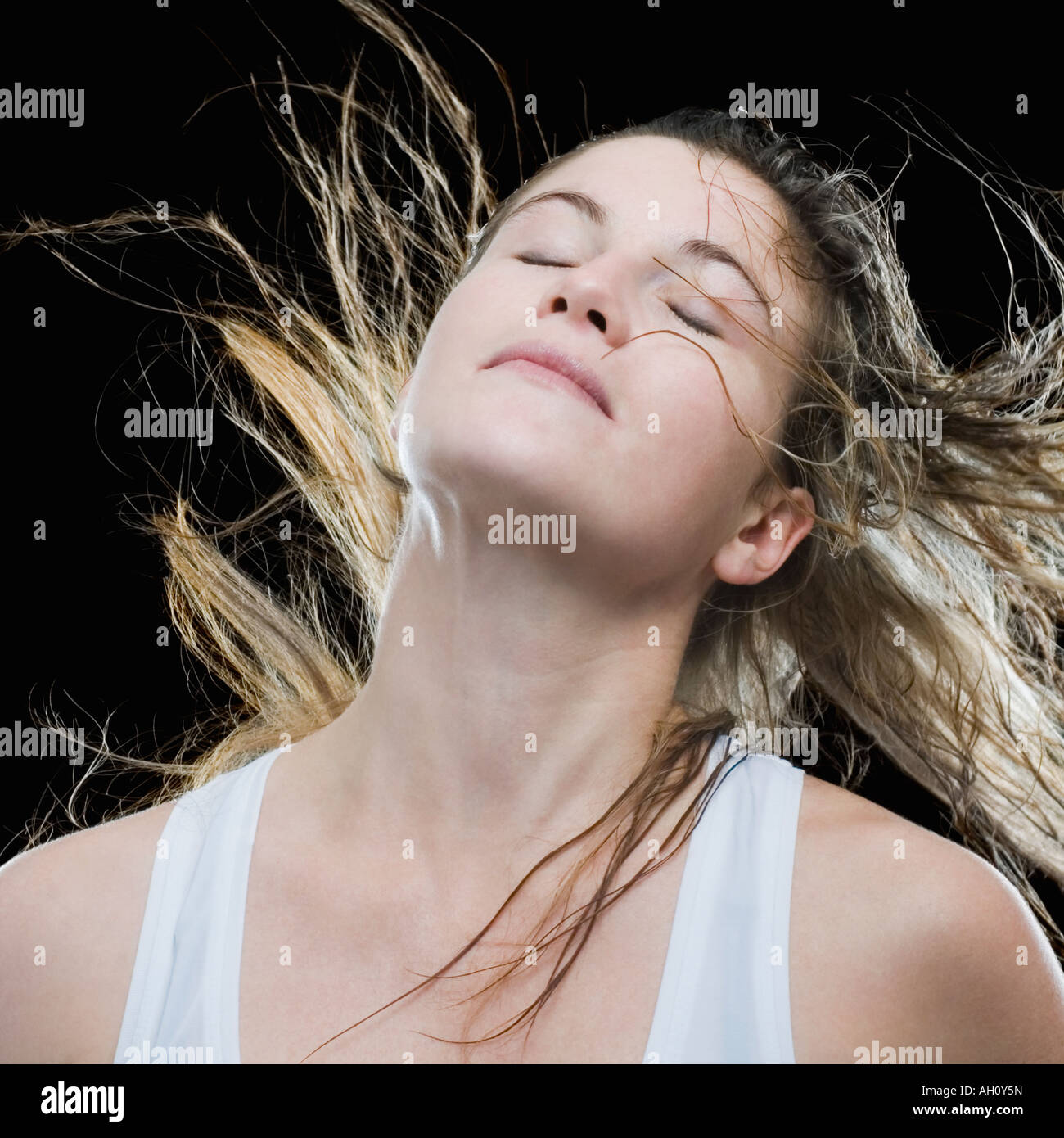 Close-up of a young woman with her eyes closed and tousled hair Stock Photo