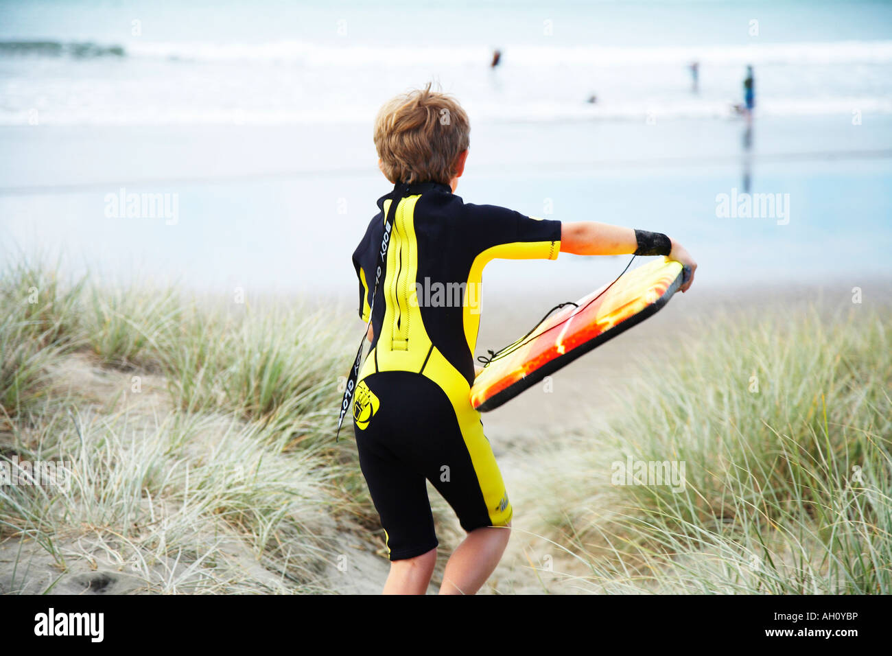 Boy carrying boogie board hi-res stock photography and images - Alamy