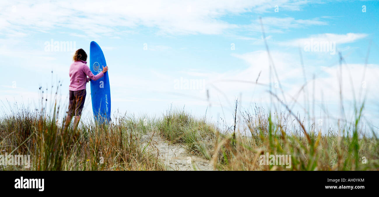 Blonde woman holding surfboard hi-res stock photography and images - Alamy