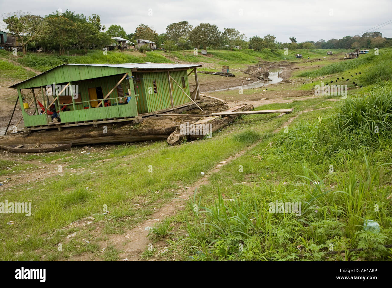Floating house,  in the dry season,  on a tributary of the Amazon Stock Photo