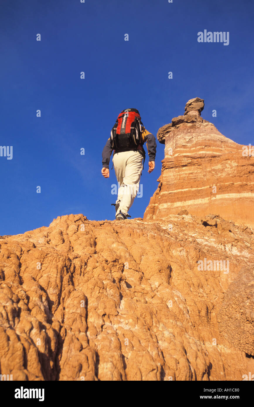 Male hiker ascending a desert ramp Stock Photo - Alamy