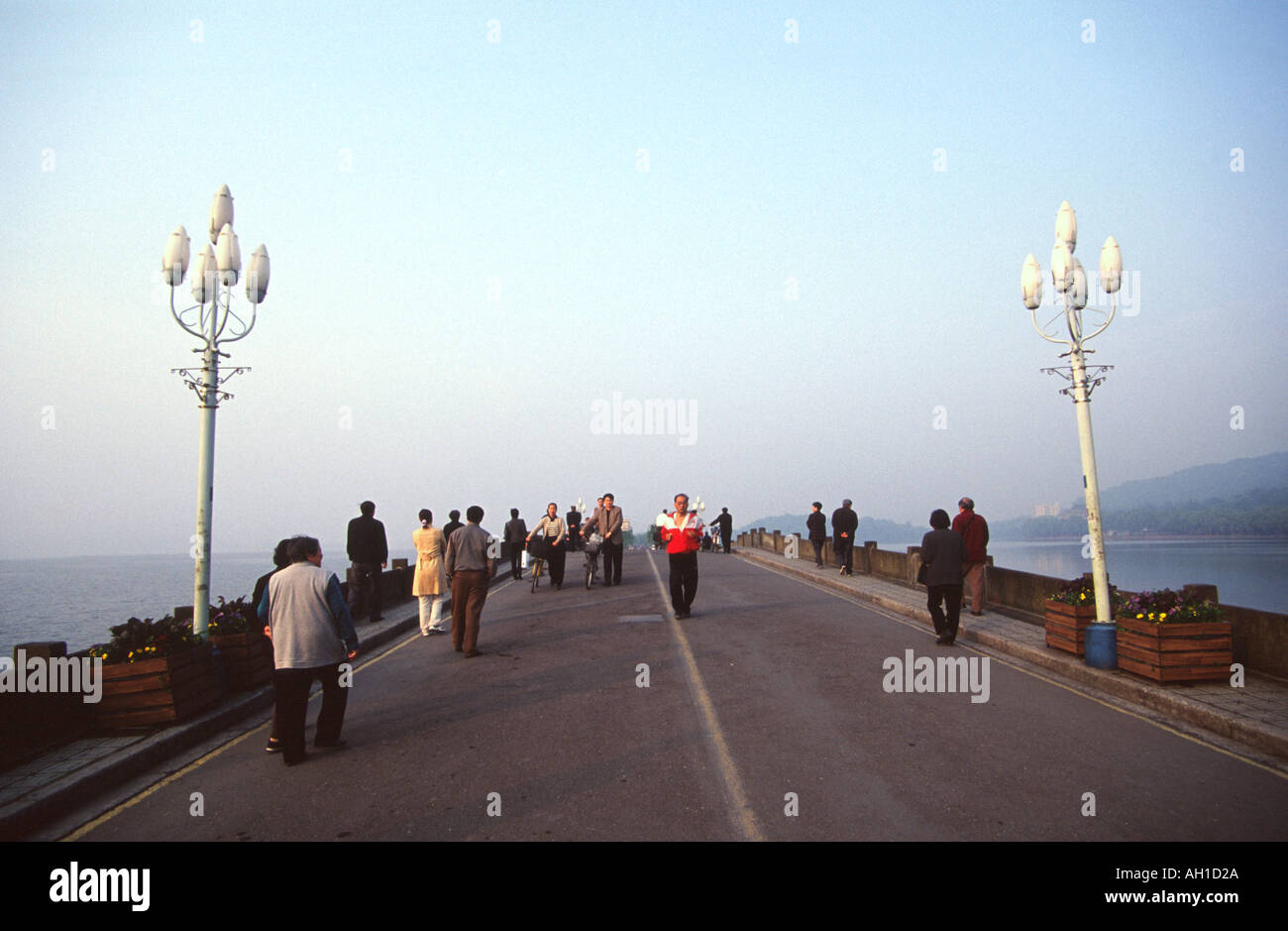 People walking over the bridge in Xi Hu HangZhou China Stock Photo