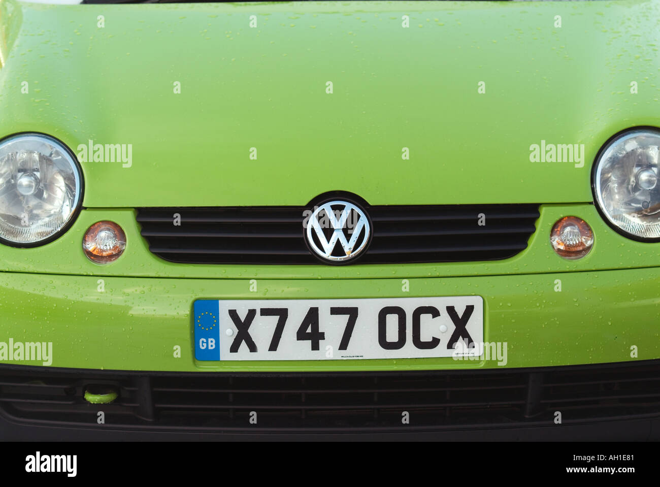 VW lupo city car number plate altered from orginal number volkswagen people car commute travel small green german car maker man Stock Photo