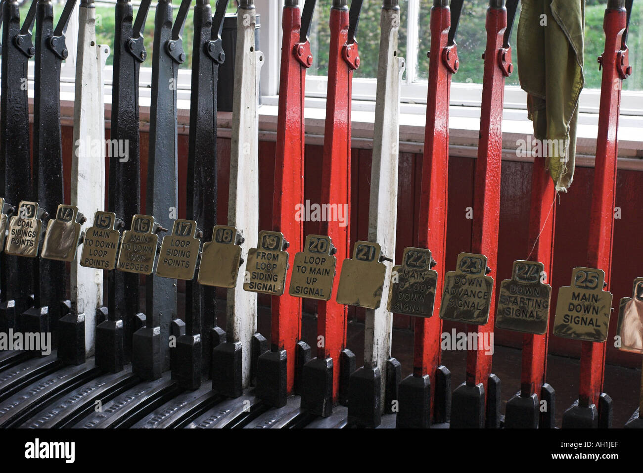 Railway signal control levers and brass labels in a restored signal box Stock Photo