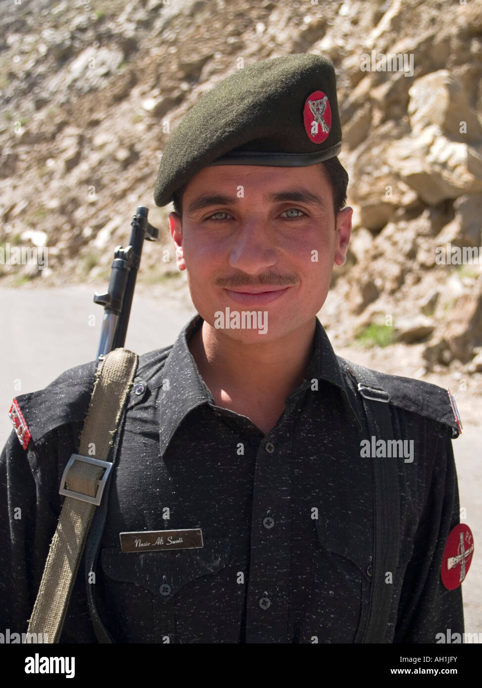 portrait of a Pakistani border guard and his rifle on the Deosai Plains