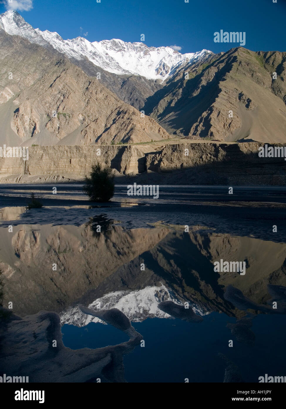reflection of the peaks of Passu in the Karakoram mountains of Pakistan Stock Photo