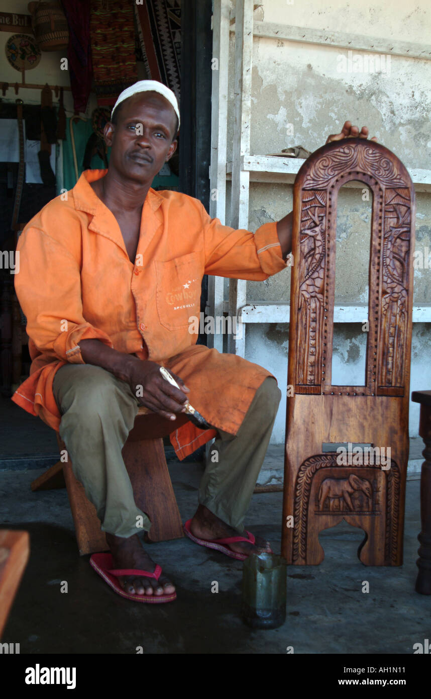 A local Lamu Town carpenter with his original carved chair. Lamu Island