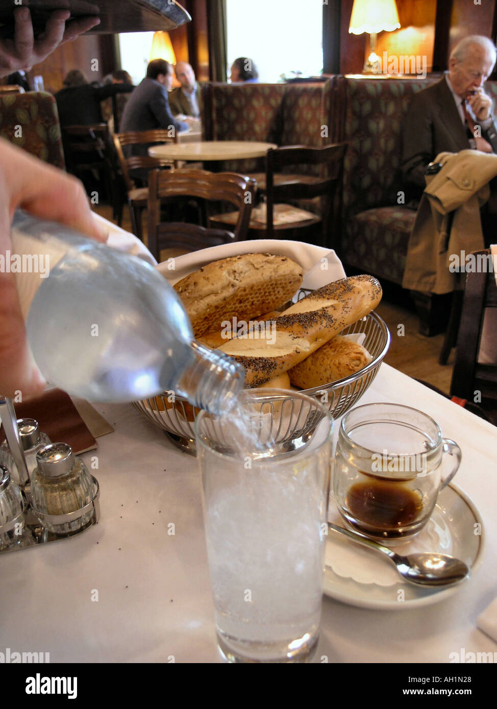 Waiter pouring water in a french cafe Stock Photo Alamy