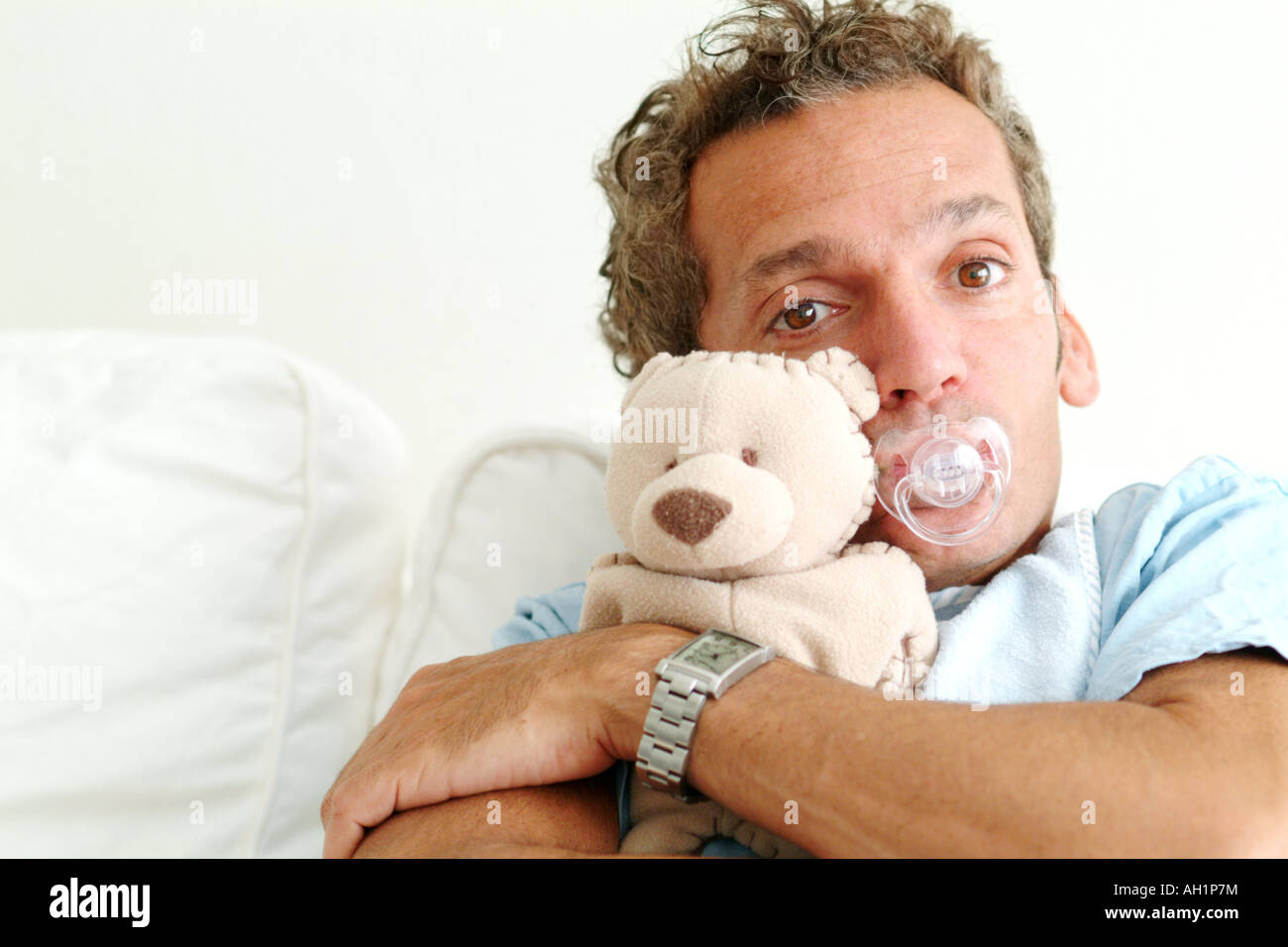 Immature Man a grown man sucking a dummy / pacifier, wearing a bib