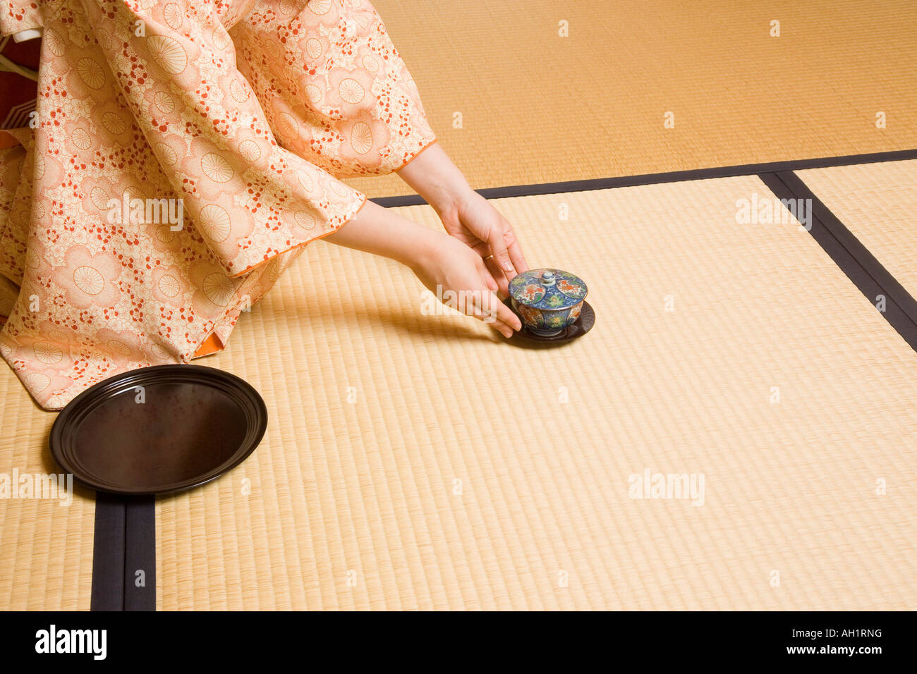 Woman serving cup of tea Stock Photo Alamy