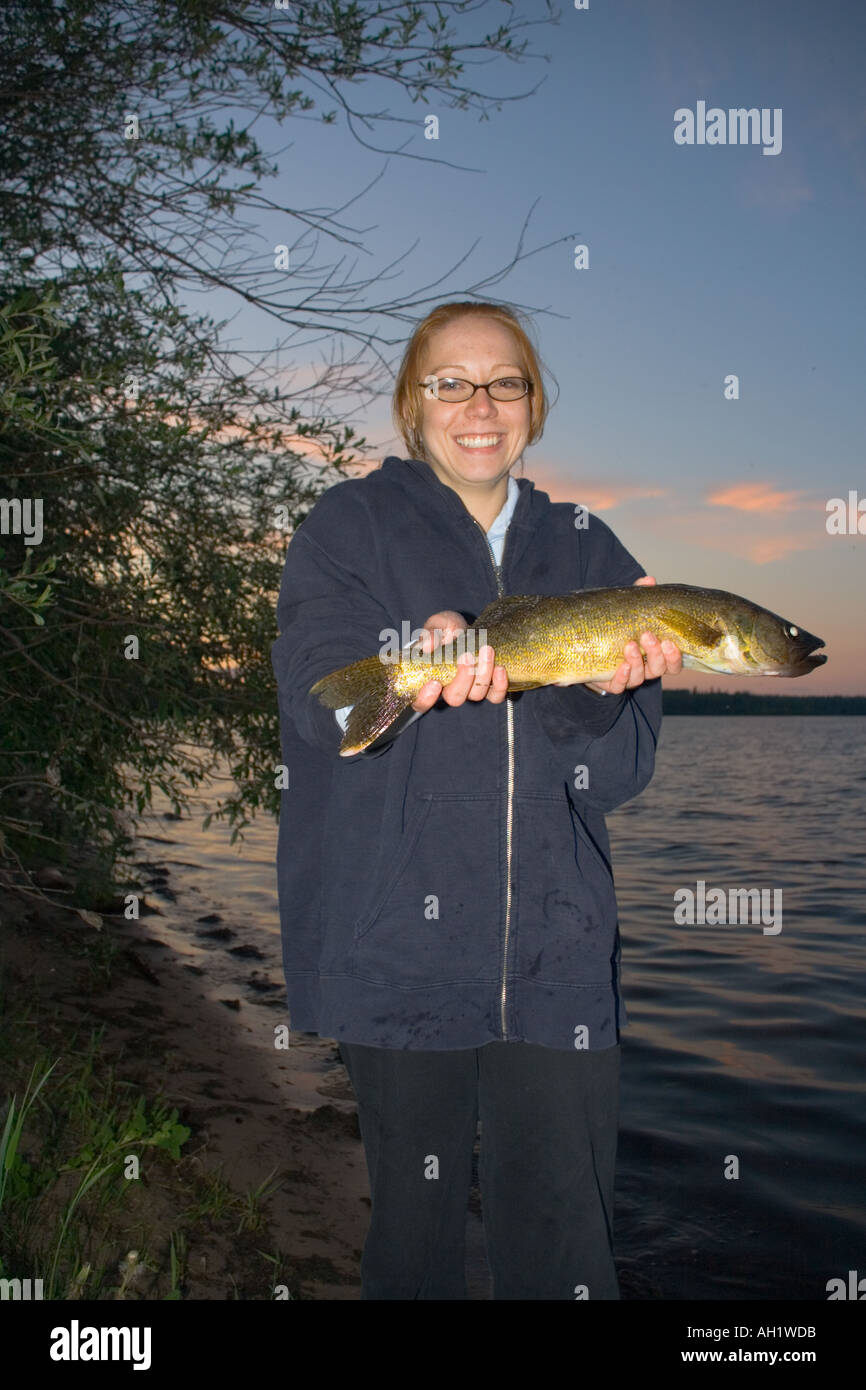 A lady holds up her catch in Alberta Canada  Stock Photo