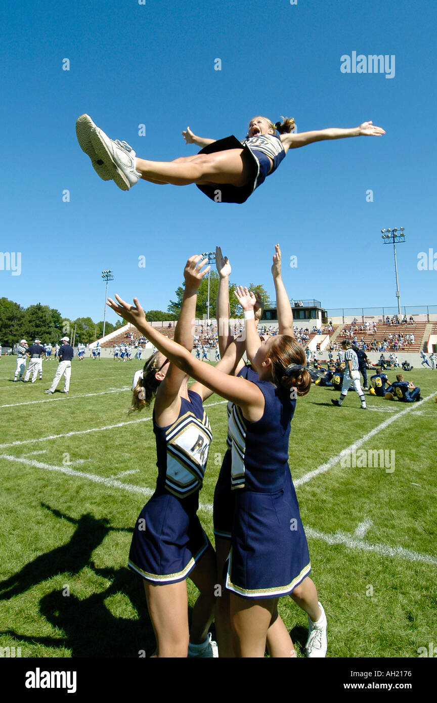 Cheerleaders Perform During Football Game risking injury Stock Photo