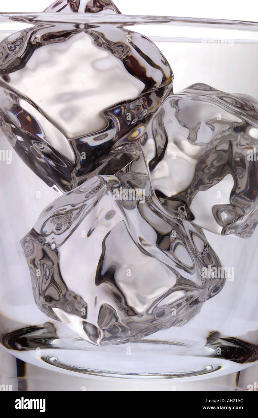 Closeup of a high-ball cocktail glass with ice silhouetted on white background Stock Photo