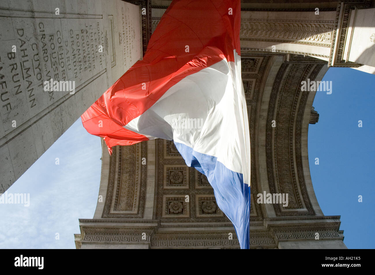 Looking up at the French tricolor under the arc de triomphe in paris france Stock Photo