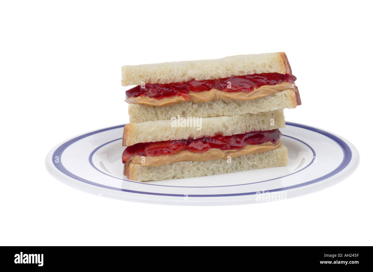 Peanut butter and jelly sandwich stacked on plate silhouetted on white background Stock Photo