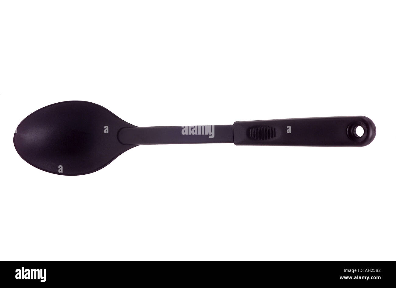 big plastic cooking spoon silhouetted on white background Stock Photo