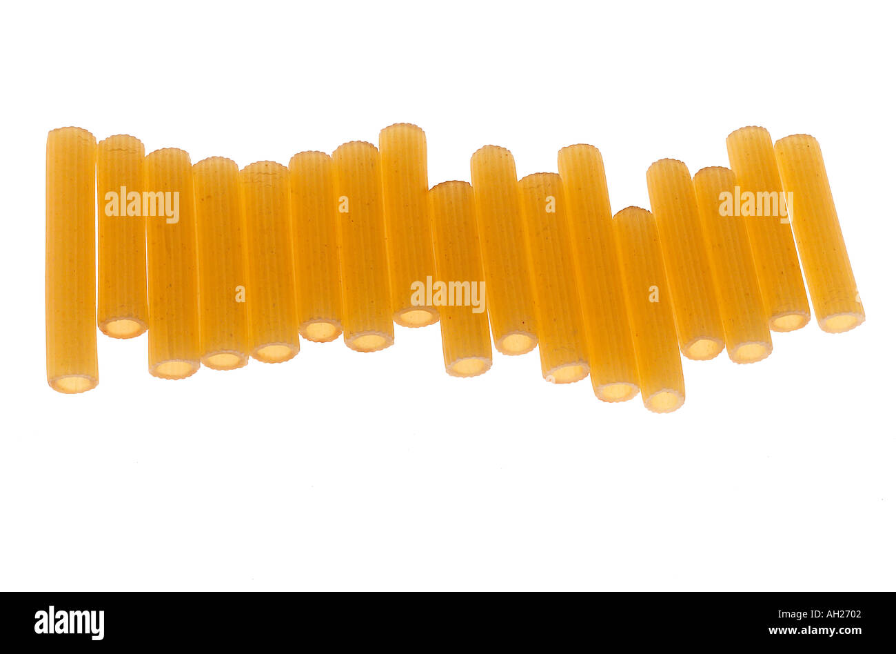raw pasta rotelli lineup sillhouetted on white background Stock Photo