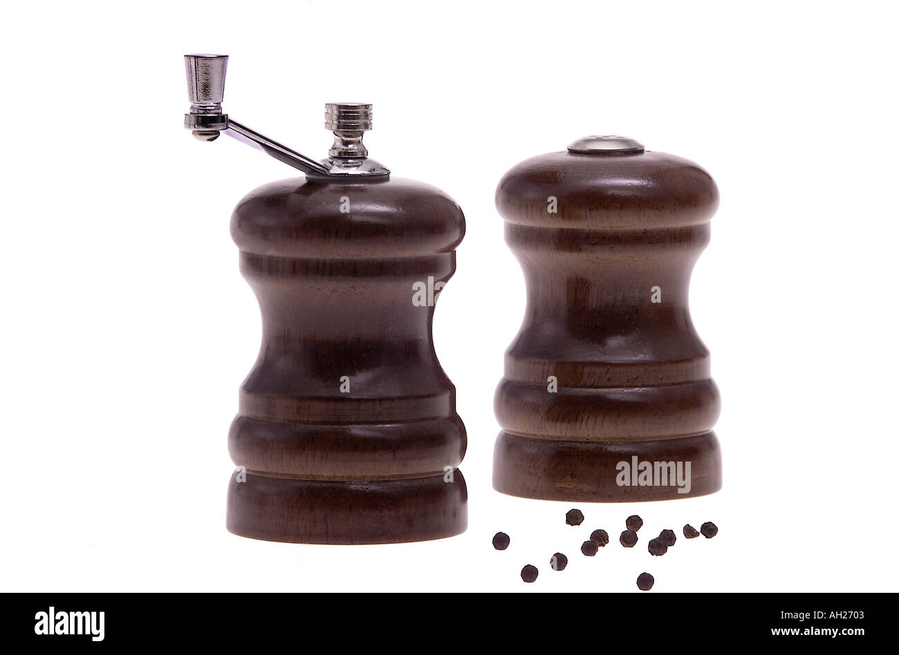 salt pepper shakers scattered pepper silhouetted on white background Stock Photo