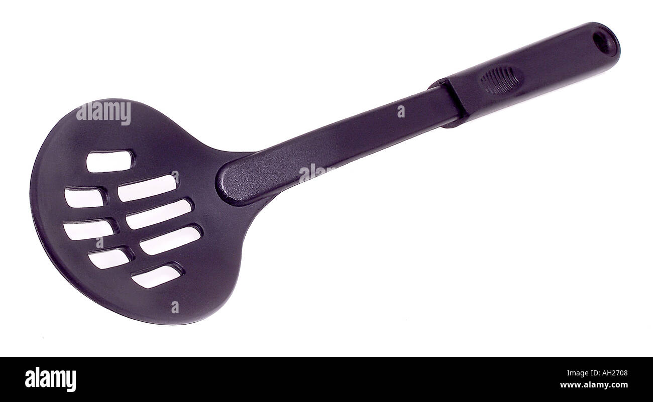slotted cooking spoon silhouetted on white background Stock Photo