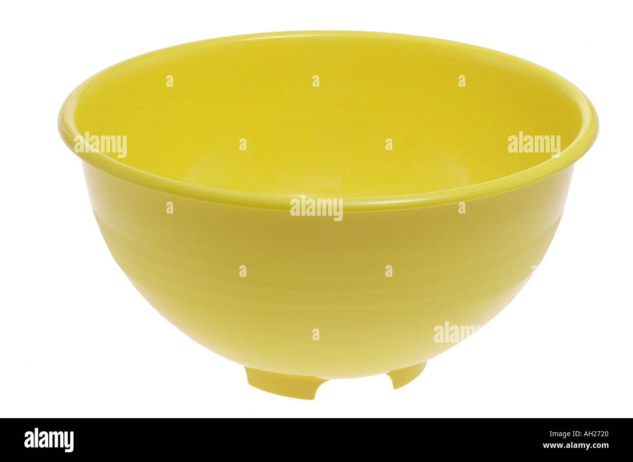 Yellow plastic mixing bowl silhouetted on a white background Stock Photo