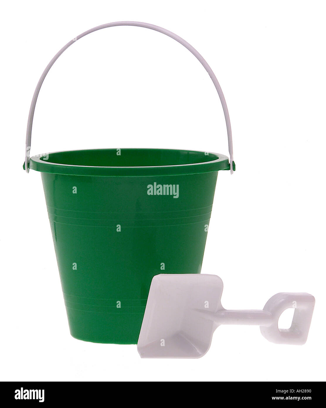 green pail and a white sand shovel silhouetted on white background