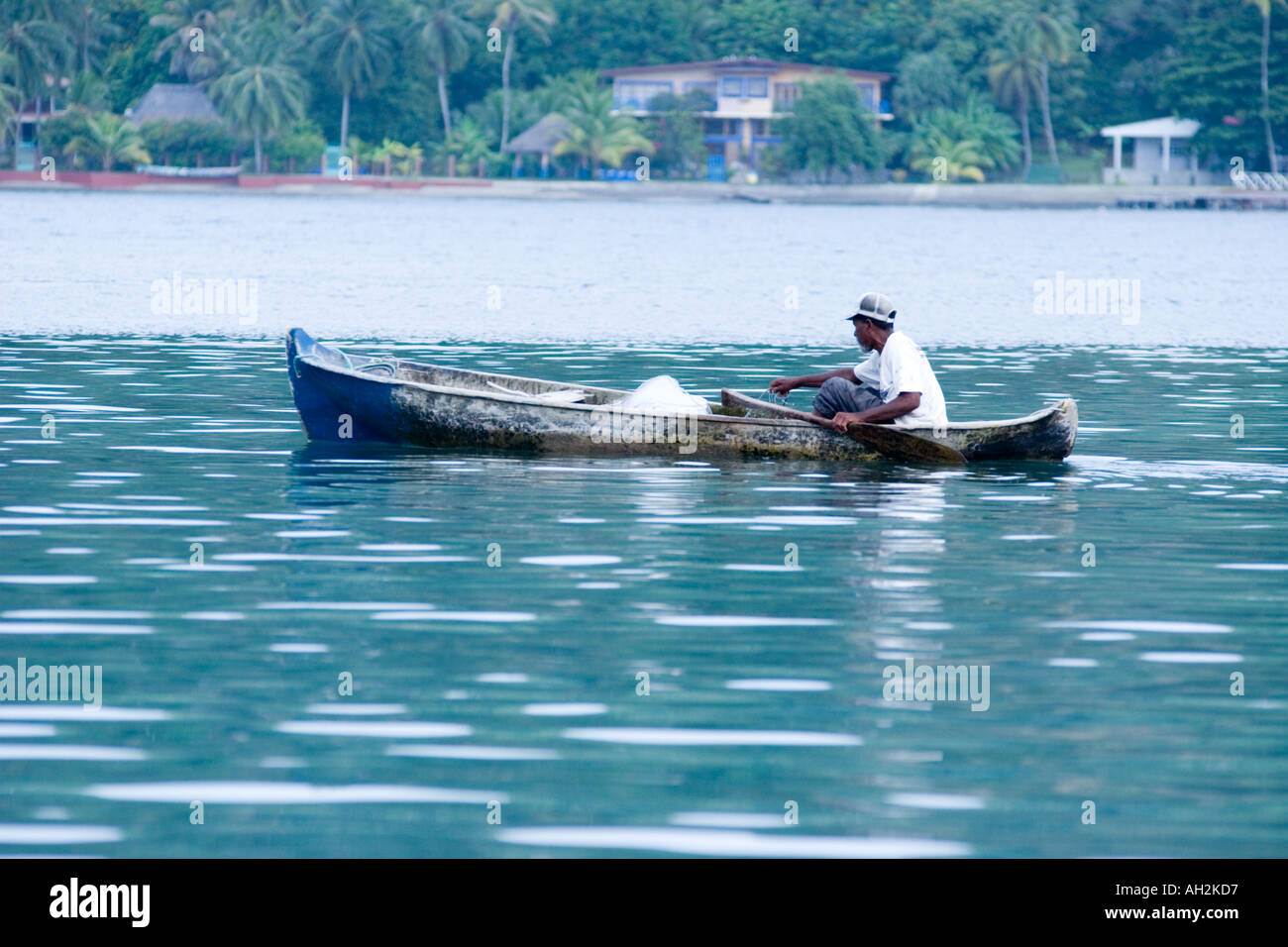 Man paddling on a dugout canoe. Isla Grande, Colon, Panama, Central America Stock Photo