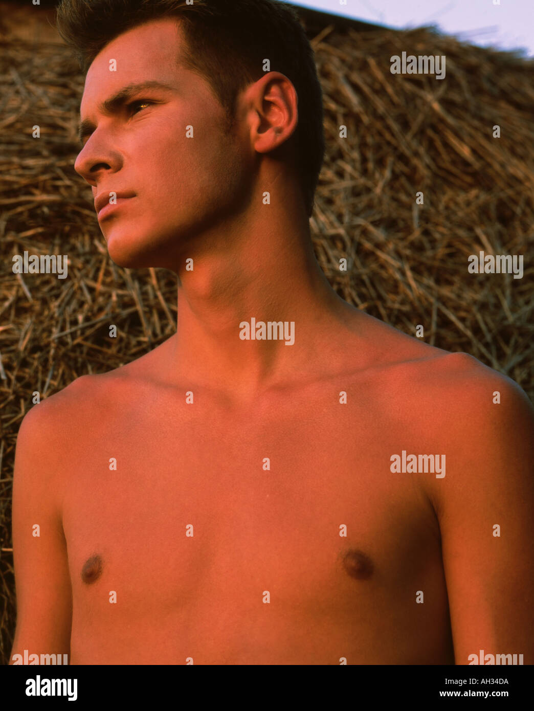 Shirtless young man lying on the straw Stock Photo