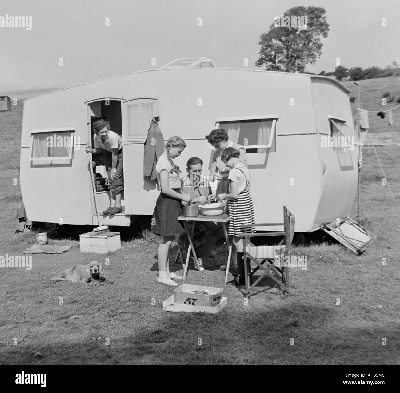 OLD VINTAGE FAMILY SNAPSHOT PHOTOGRAPH OF FAMILY ON CAMPING HOLIDAY WITH CARAVAN Stock Photo
