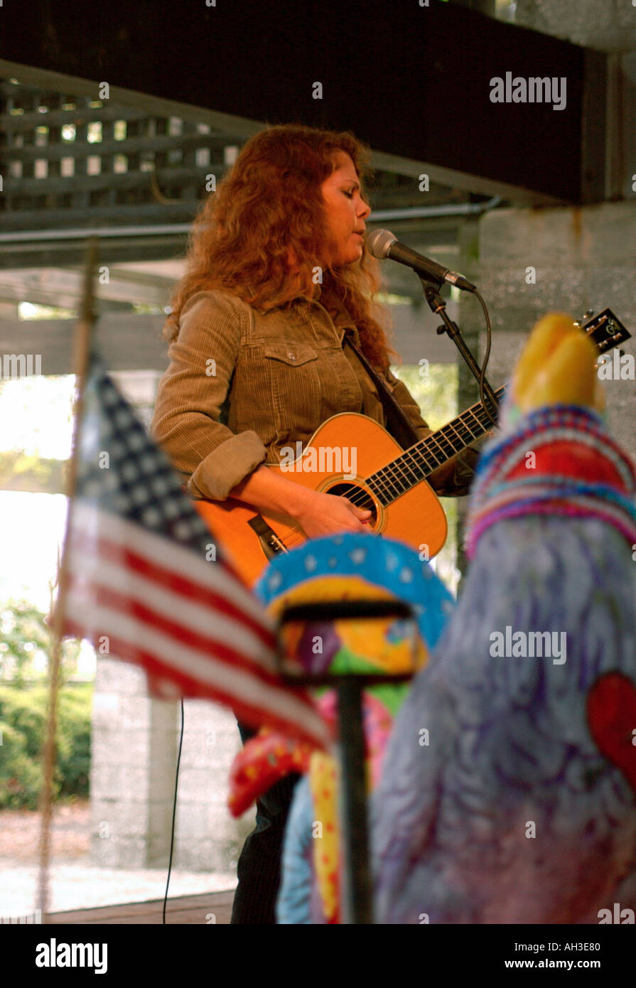 Sultry Caucasian Female Singer Rebecca Folson Performing With US Flag Behind Her at Outdoor Concert Editorial Use Only USA Stock Photo