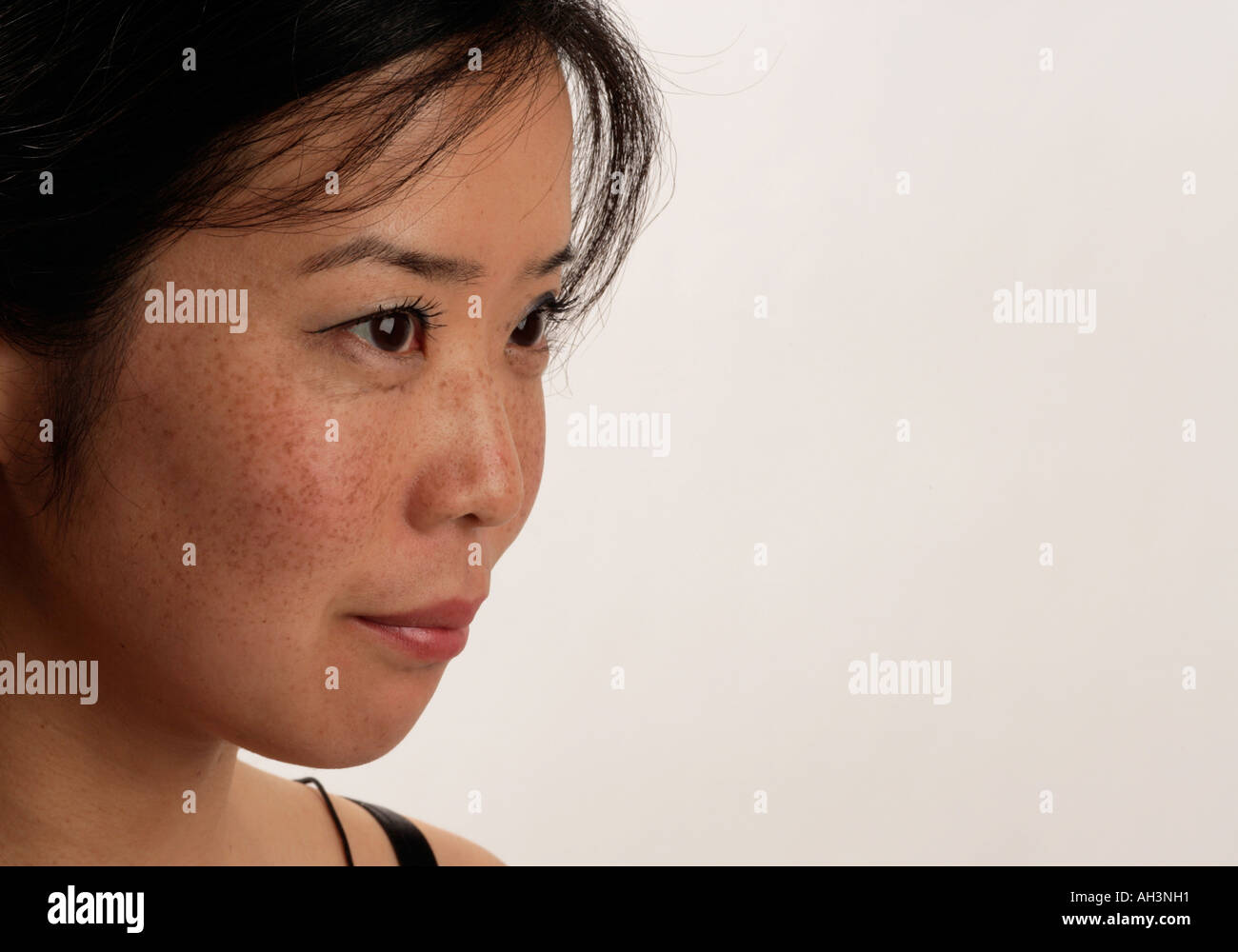 Young asian womans face with freckles Stock Photo - Alamy