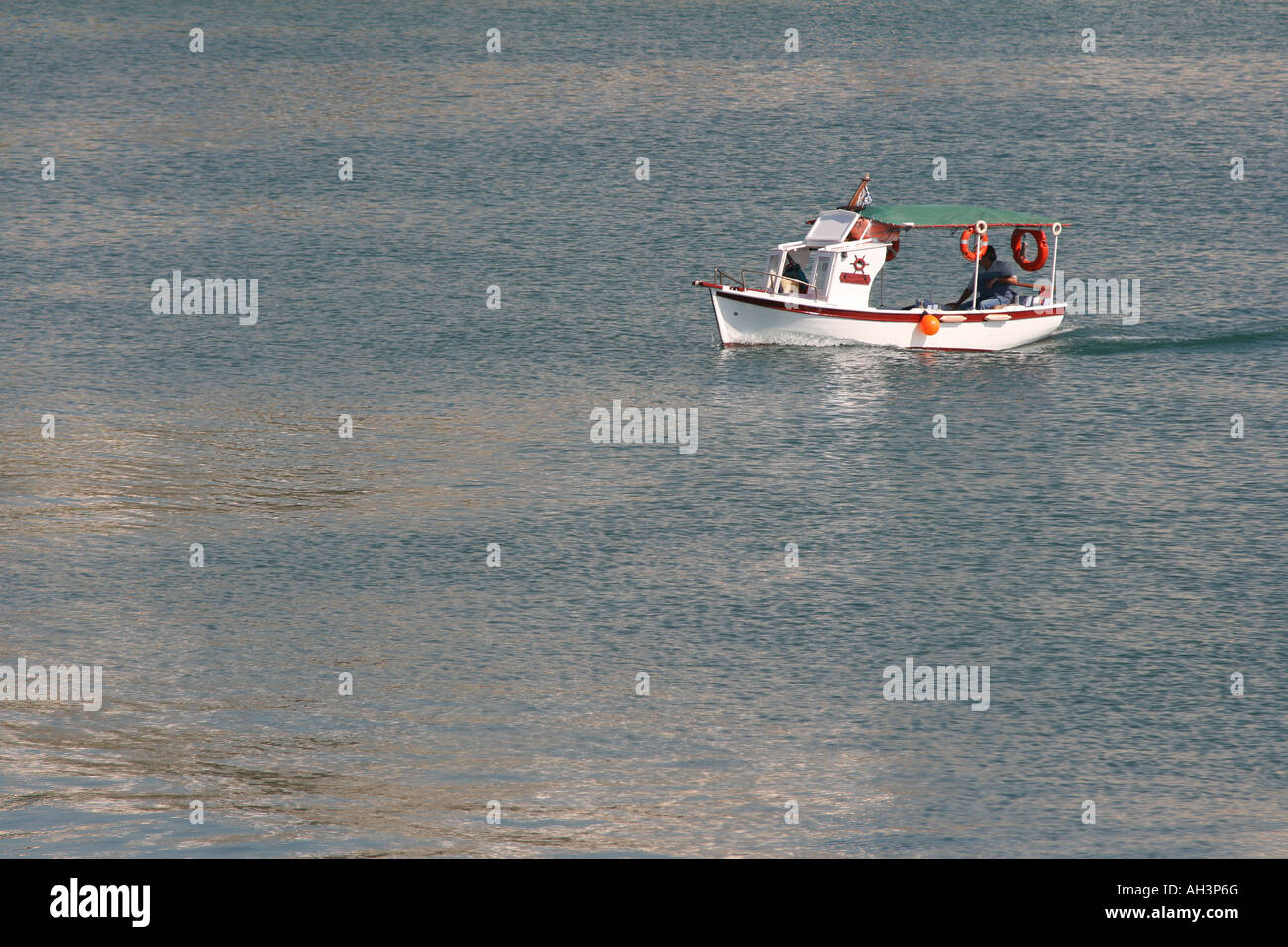 traditional wooden small boat sailing in the sea Stock Photo