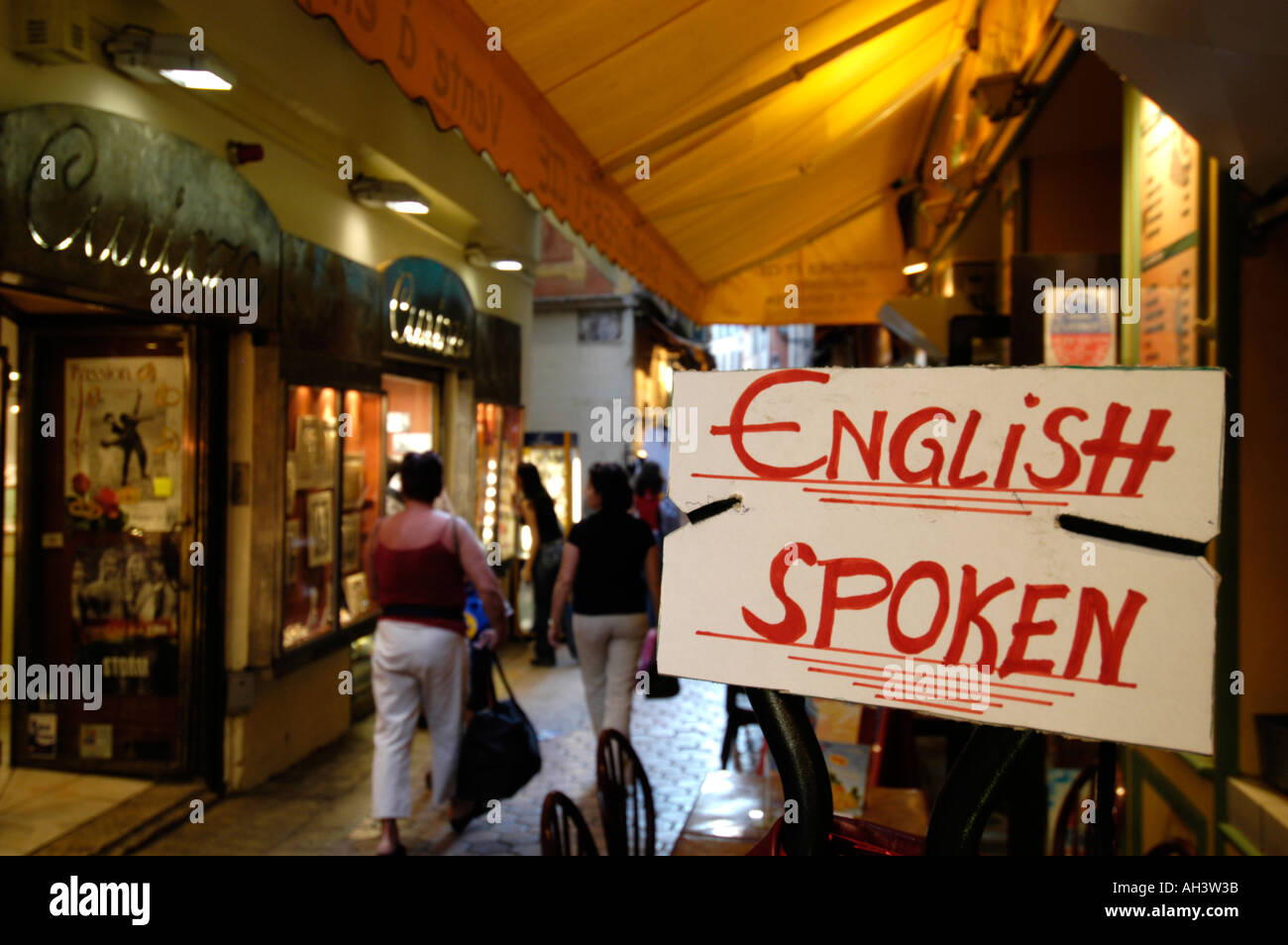 ENGLISH SPOKEN sign outside a shop, France Stock Photo