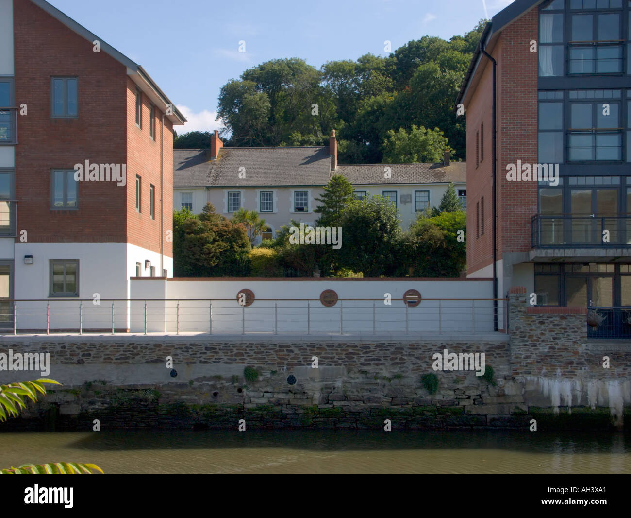 New old housing in Truro with modern riverside apartments in the foreground and older traditional cottages in the background Stock Photo