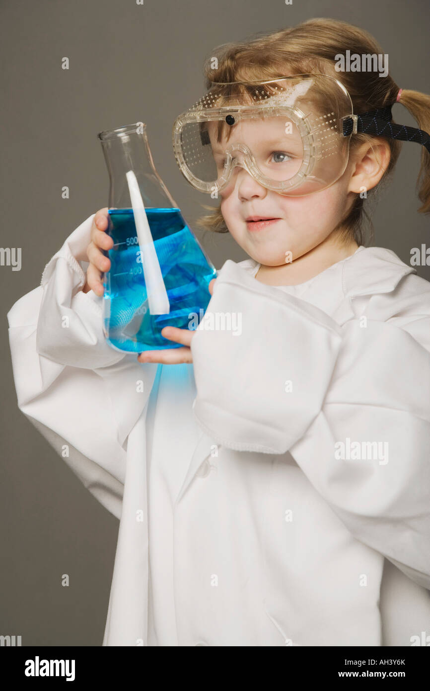 Little girl in safety glasses, holding beaker Stock Photo Alamy