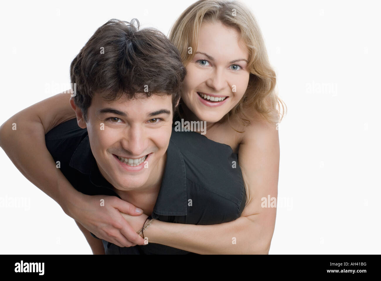 Portrait of a young woman embracing a young man Stock Photo - Alamy