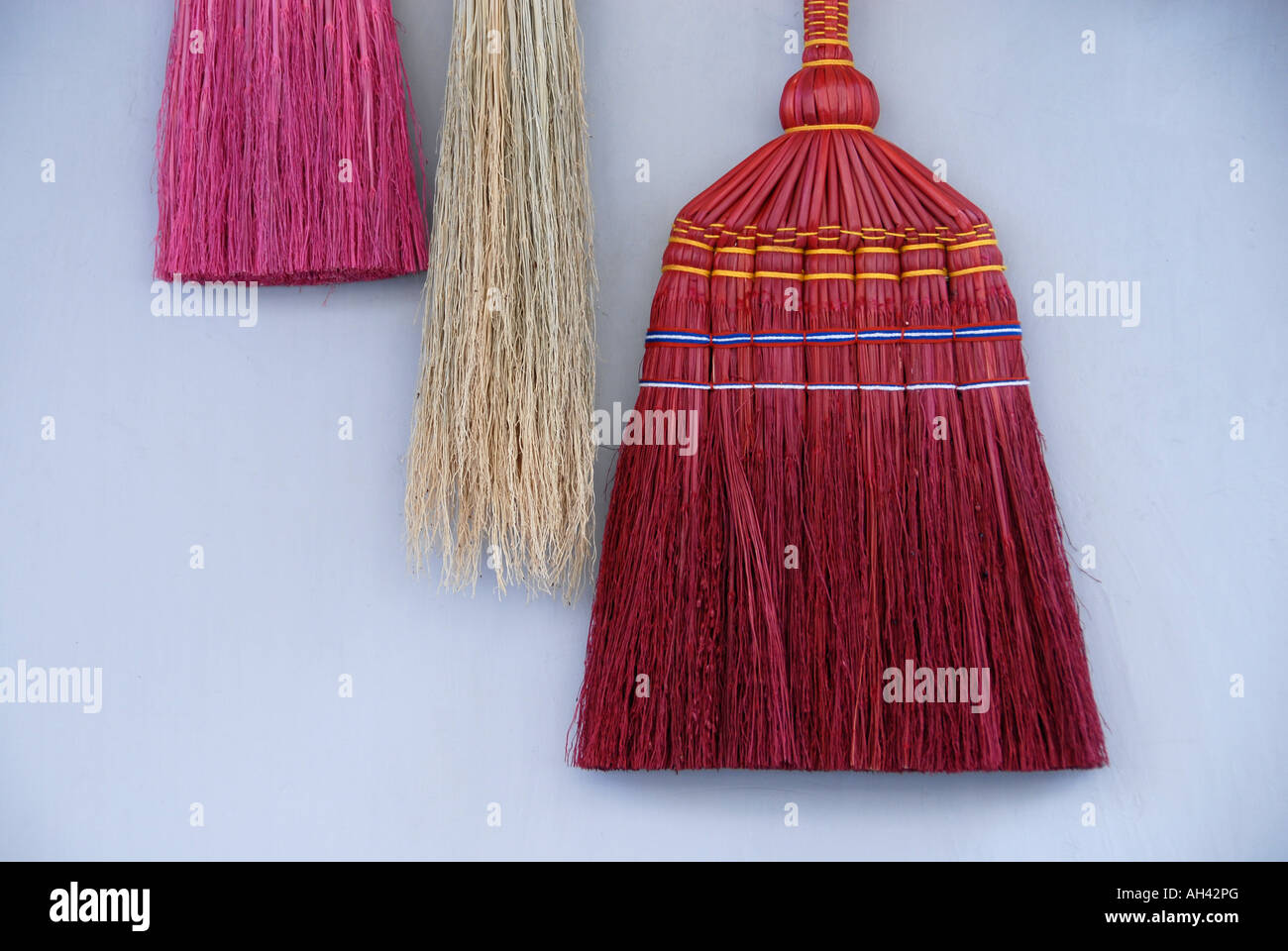 Collection of traditionally besom brooms with bristles made from corn husks. Stock Photo