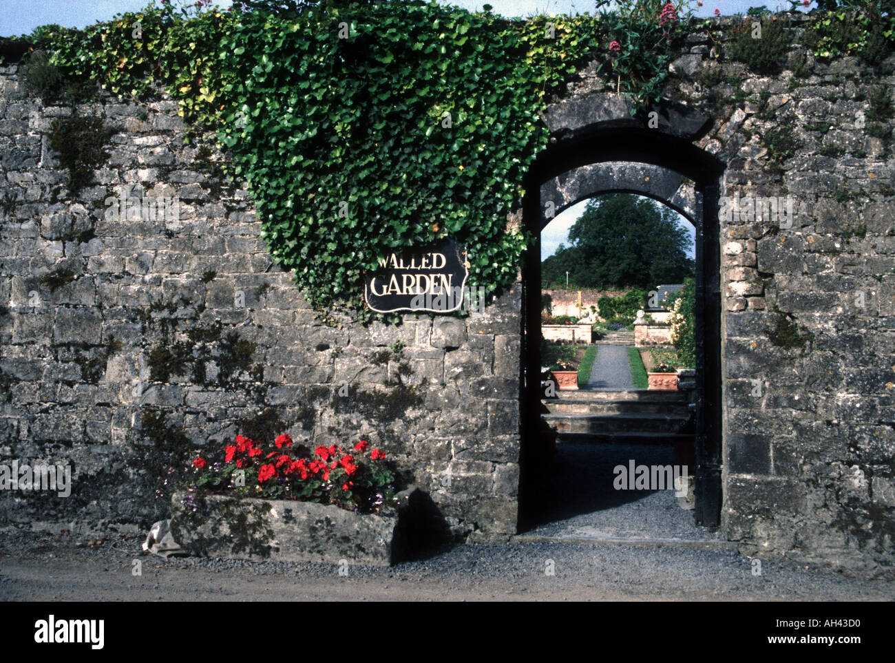 Entrance To Forma Stone Walled Garden With Red Flowers And Ivy Stock Photo Alamy Entrance To Forma Stone Walled Garden With Red Flowers And Ivy Stock Photo Alamy
