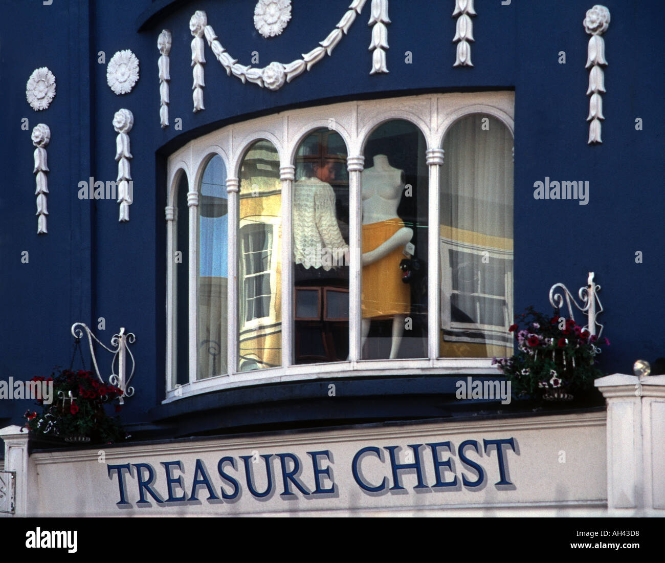 Wedgewood blue and white decor frames a shop girl in a second floor