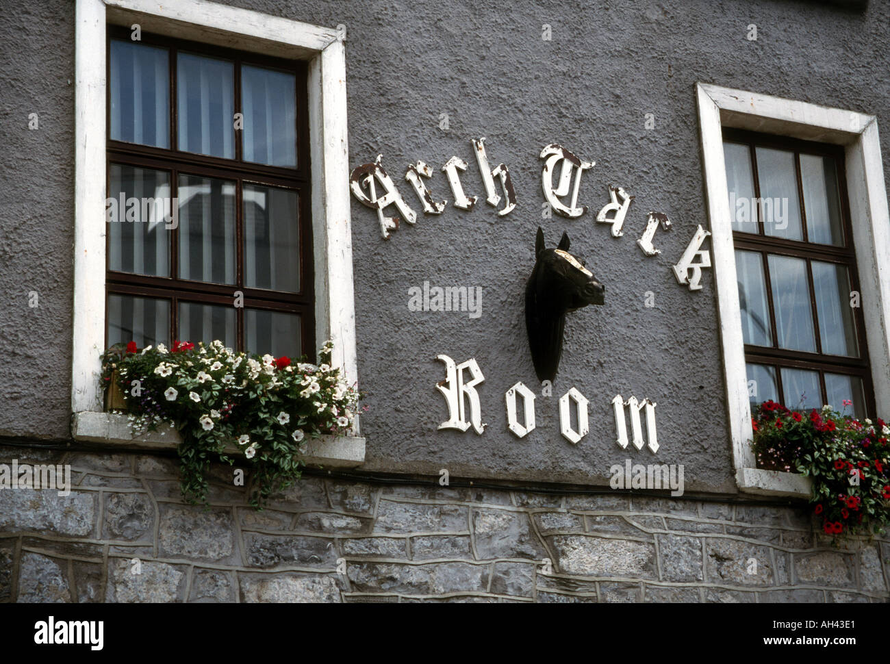 Windows and restaurant sign with horsehead sculpture and red and whites