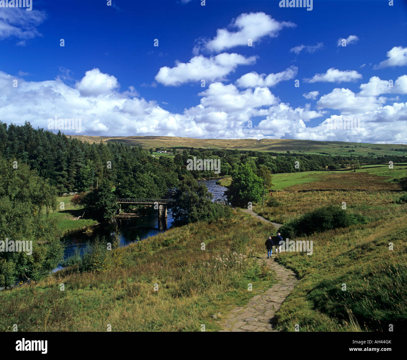 A couple walk on a path by the the River Tees in Teesdale Stock Photo